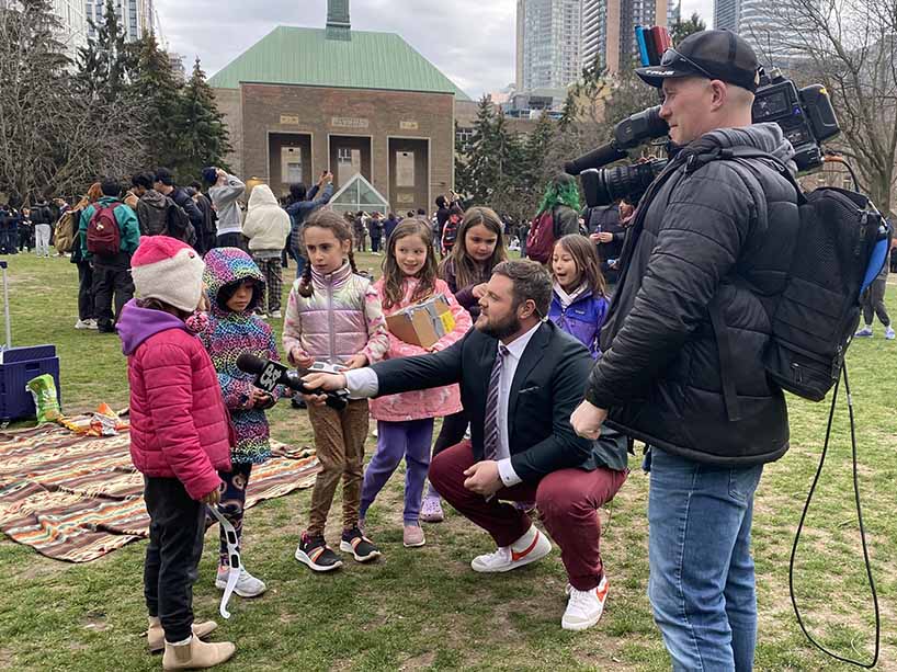 A group of young girls are interviewed by a CP24 reporter in the TMU quad.